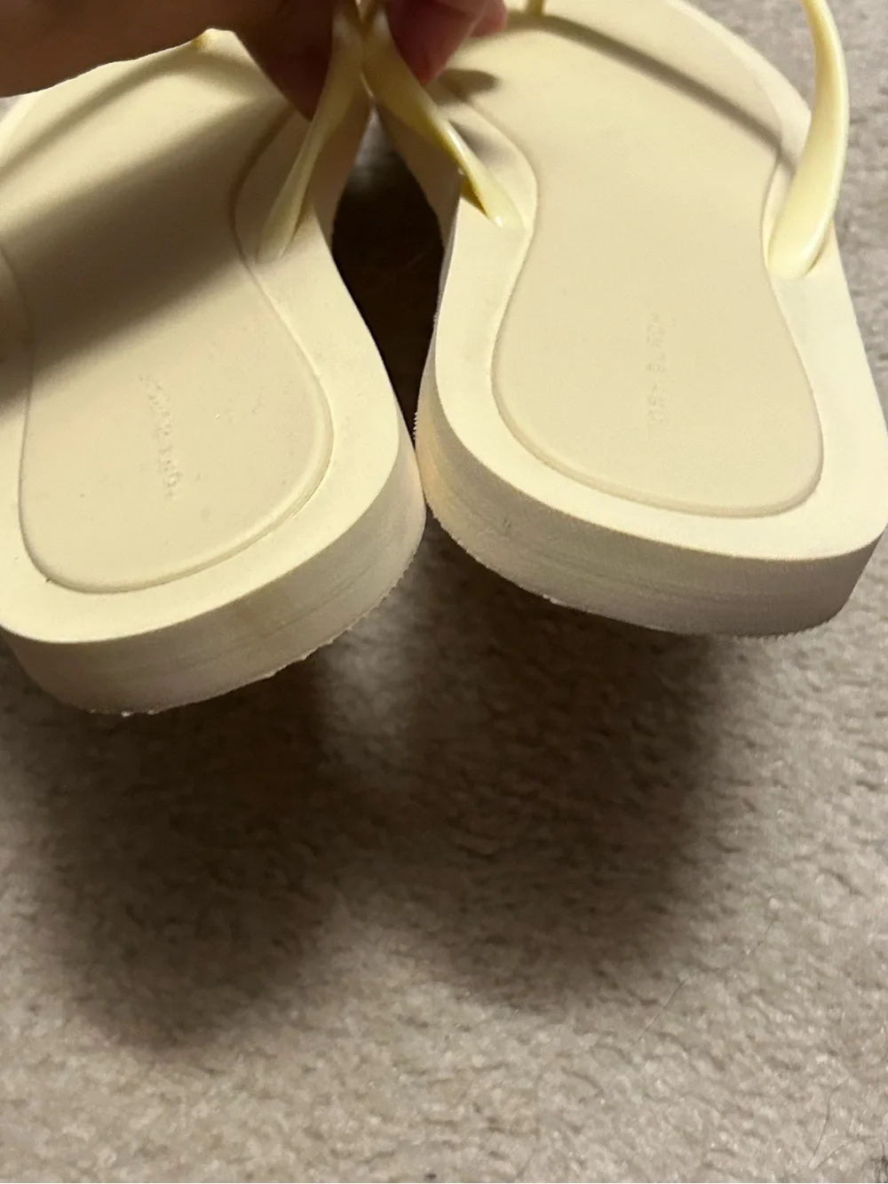 TORY BURCH KIRA padded flip flops in light yellow.